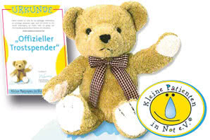 Das Bild zeigt einen Teddy und eine Urkunde, die bestätigen, dass der Teddy als offizieller Trostspender für kranke Kinder dient.