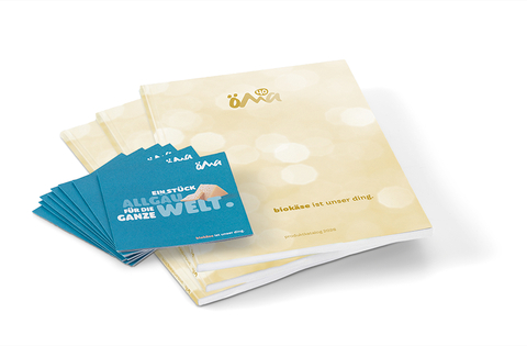 The image displays a product catalogue and several information cards highlighting our organic cheeses and their deep connection to the Allgäu region.